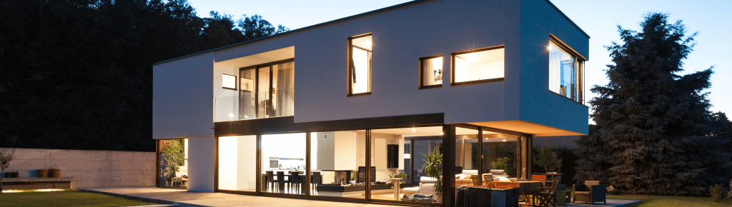 wide angle picture of a modern and stylish smart home with an open floor plan and floor to ceiling windows