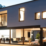 wide angle picture of a modern and stylish smart home with an open floor plan and floor to ceiling windows