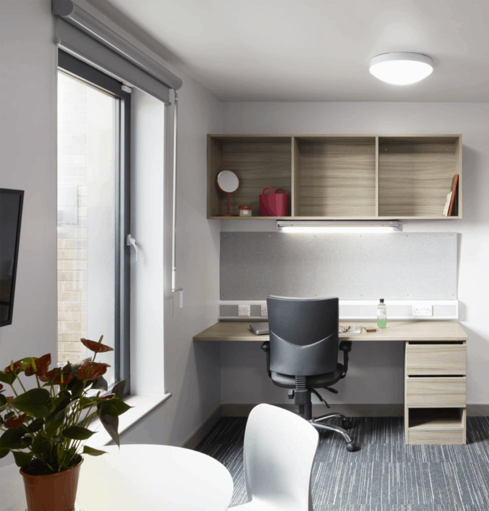 student accommodation bedroom with desk in background and sirios roller blind in window